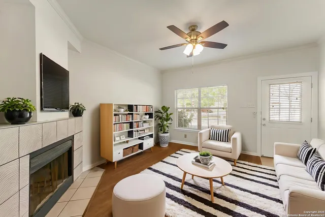 a living room with furniture a flat screen tv and a fireplace