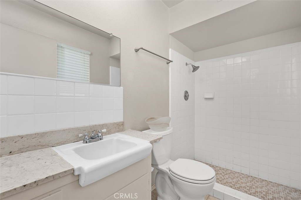 26480 Ridgemoor Road Menifee, CA 92586 - Photo 12 of 32 a bathroom with a sink toilet and shower