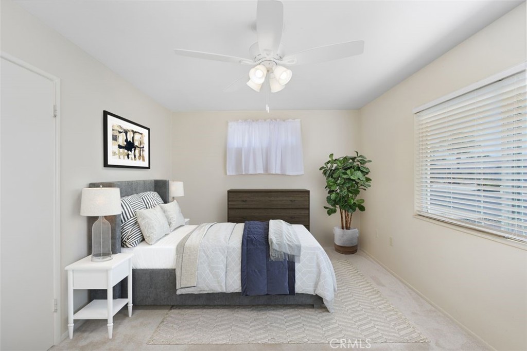26480 Ridgemoor Road Menifee, CA 92586 - Photo 13 of 32 a spacious bedroom with a bed and a potted plant