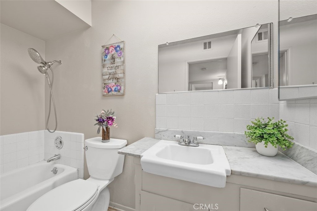 26480 Ridgemoor Road Menifee, CA 92586 - Photo 14 of 32 a bathroom with a sink mirror vanity and toilet