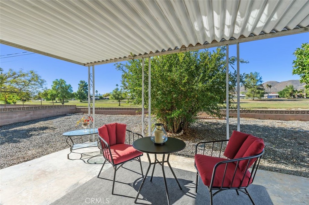 26480 Ridgemoor Road Menifee, CA 92586 - Photo 15 of 32 a patio with a table and chairs