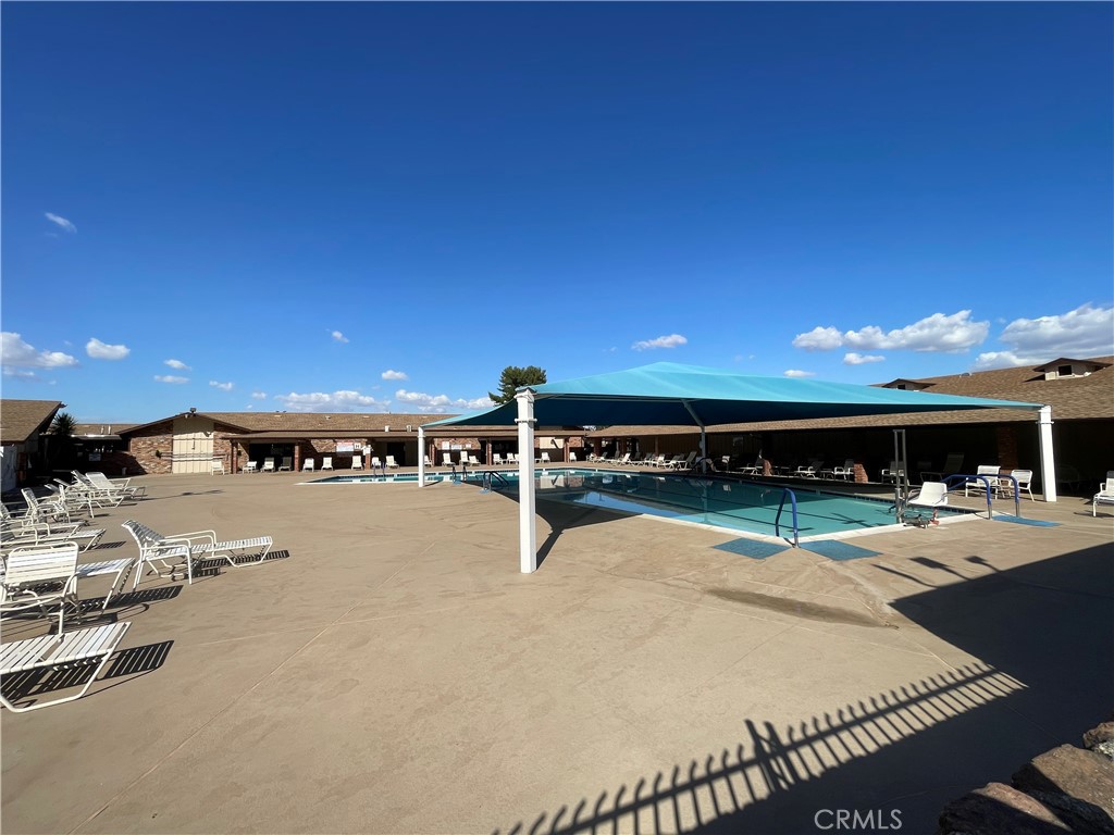 26480 Ridgemoor Road Menifee, CA 92586 - Photo 16 of 27 a view of a swimming pool with outdoor seating