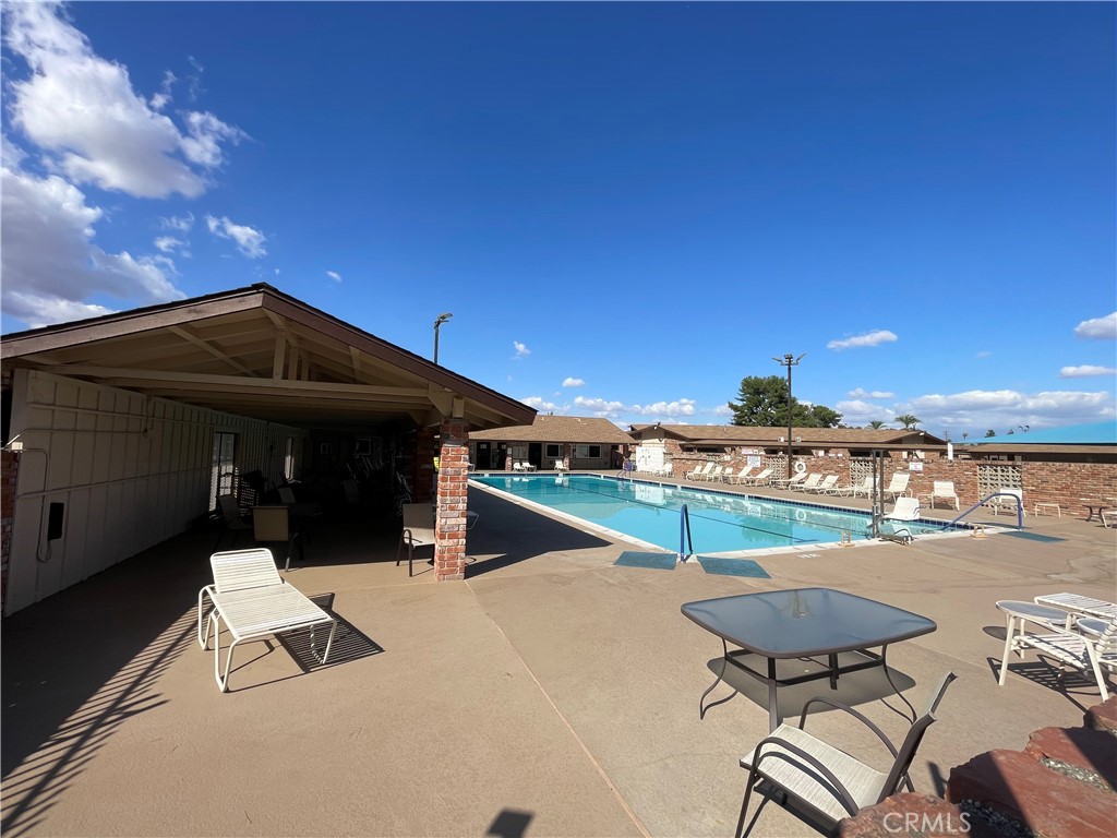 26480 Ridgemoor Road Menifee, CA 92586 - Photo 20 of 32 a view of a terrace with a table and chairs under an umbrella