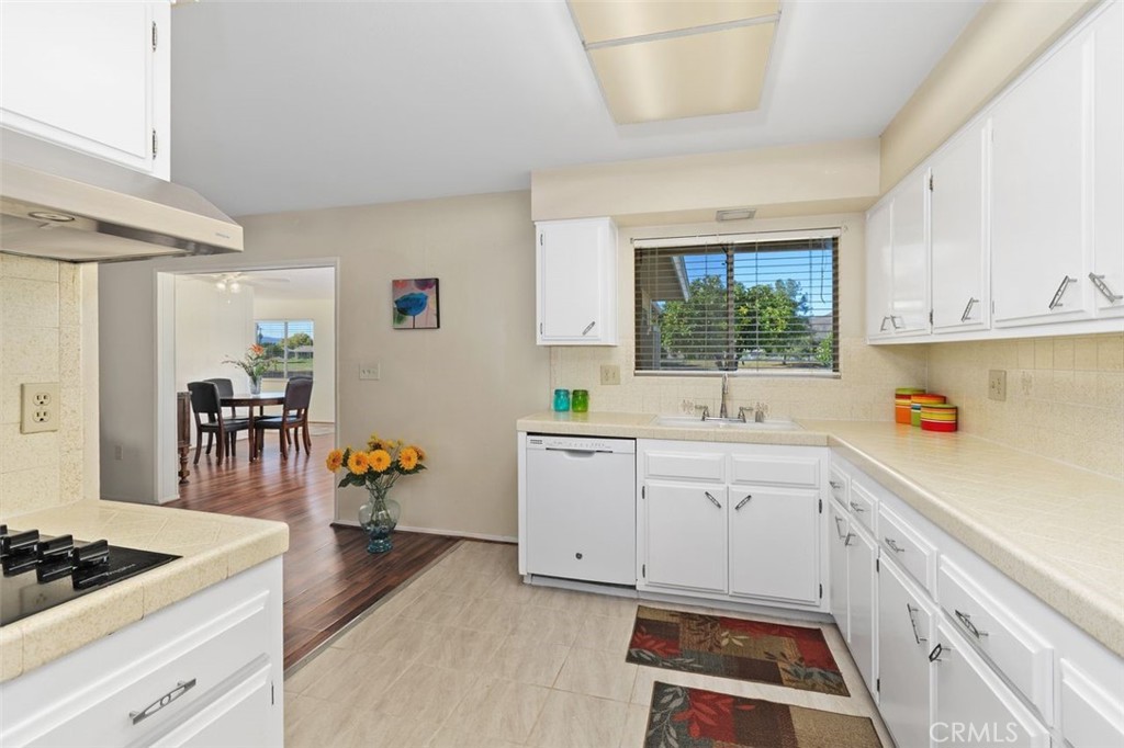 26480 Ridgemoor Road Menifee, CA 92586 - Photo 4 of 32 a kitchen with a sink stove and cabinets