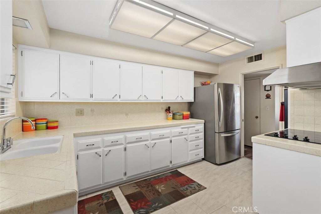 26480 Ridgemoor Road Menifee, CA 92586 - Photo 6 of 32 a kitchen with refrigerator and cabinets
