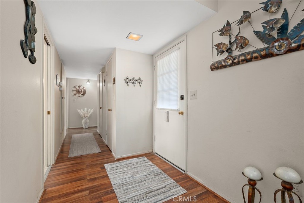 26480 Ridgemoor Road Menifee, CA 92586 - Photo 9 of 32 a view of a hallway with wooden floor and closet