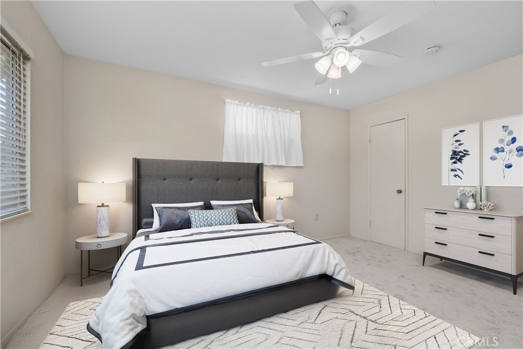 26480 Ridgemoor Road Menifee, CA 92586 - Photo 10 of 32 a bedroom with a bed and a chandelier