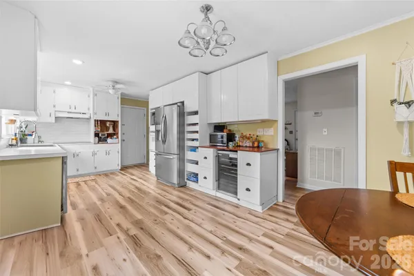 a kitchen with stainless steel appliances granite countertop a refrigerator and a stove top oven