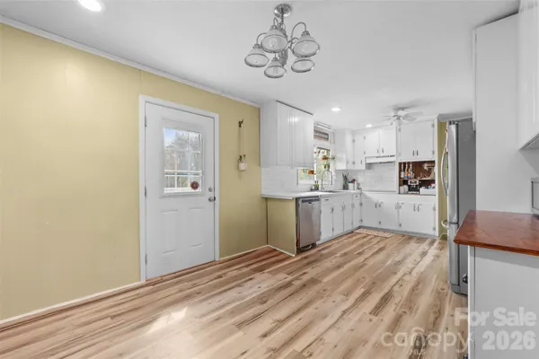 a view of a kitchen with wooden floor