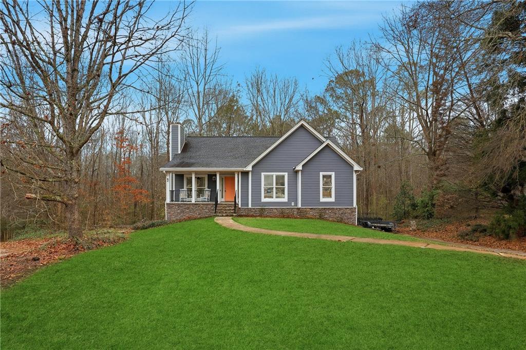 125 Cardinal Court Covington, GA 30016 - Photo 1 of 37 a front view of a house with yard and green space