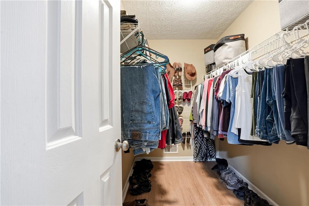125 Cardinal Court Covington, GA 30016 - Photo 16 of 37 a view of walk in closet with clothes