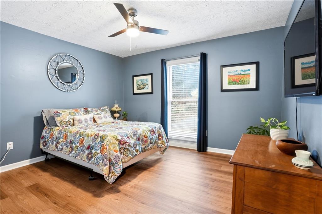 125 Cardinal Court Covington, GA 30016 - Photo 19 of 37 a bedroom with a bed and painting on the wall