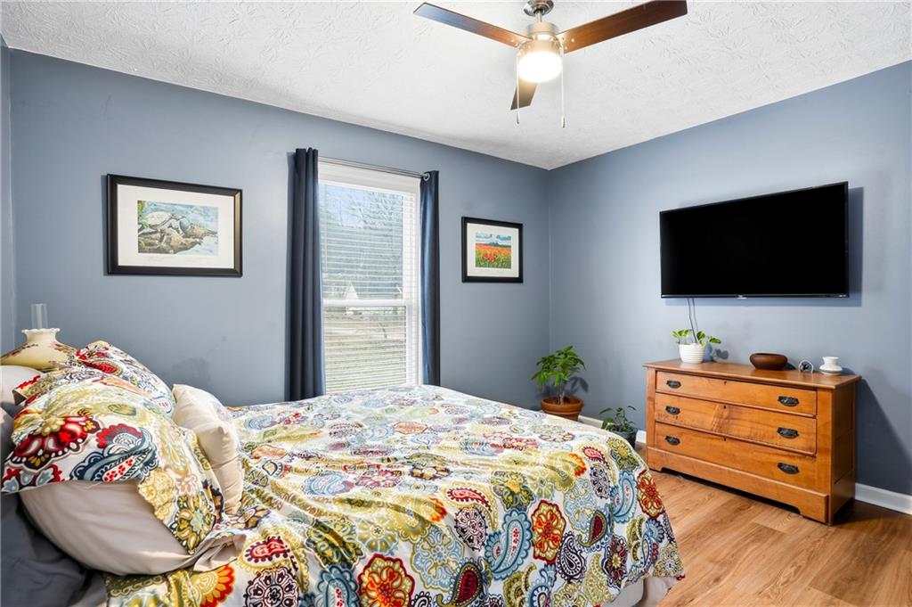 125 Cardinal Court Covington, GA 30016 - Photo 20 of 37 a bedroom with a bed and a flat screen tv