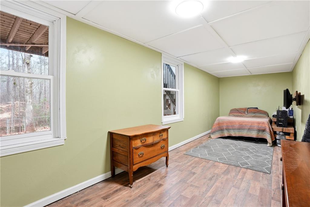 125 Cardinal Court Covington, GA 30016 - Photo 23 of 37 a bedroom with a bed and wooden floor