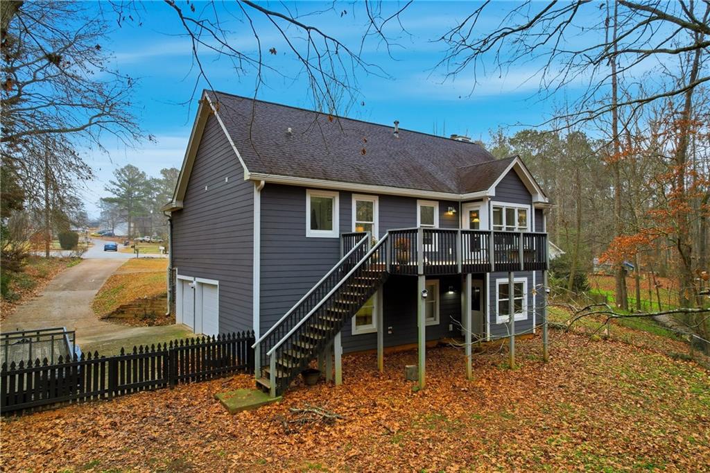 125 Cardinal Court Covington, GA 30016 - Photo 33 of 37 a wooden house with a large window and wooden fence