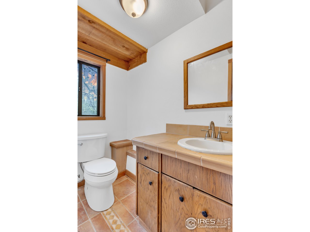 926 Mountain Meadows Road Boulder, CO 80302 - Photo 16 of 38 a bathroom with a toilet sink and mirror