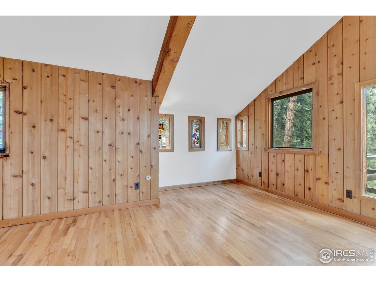 926 Mountain Meadows Road Boulder, CO 80302 - Photo 17 of 38 a view of an empty room with wooden floor and a window