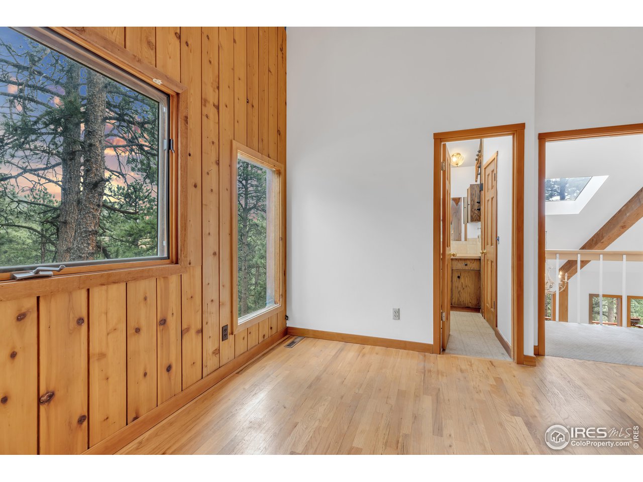926 Mountain Meadows Road Boulder, CO 80302 - Photo 18 of 38 a view of an empty room with wooden floor and a window