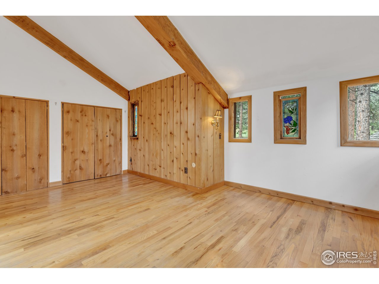 926 Mountain Meadows Road Boulder, CO 80302 - Photo 19 of 38 a view of an empty room with wooden floor