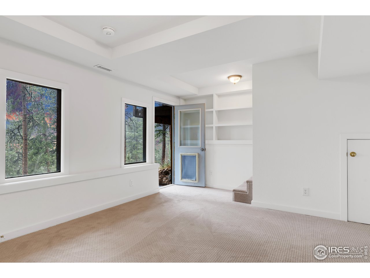 926 Mountain Meadows Road Boulder, CO 80302 - Photo 24 of 38 a view of an empty room with a window and wooden floor