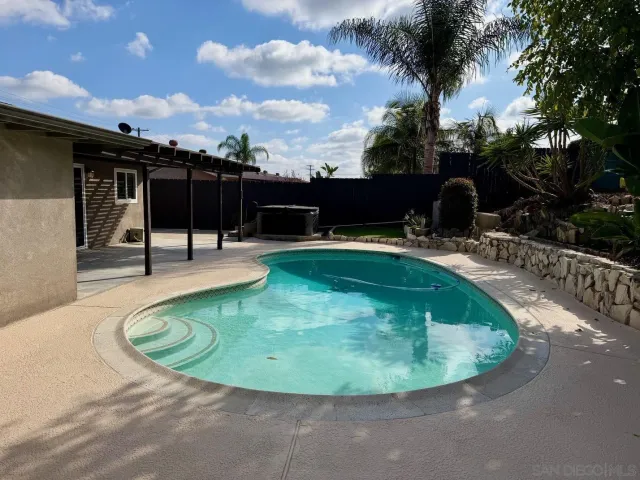 a view of a swimming pool with a patio