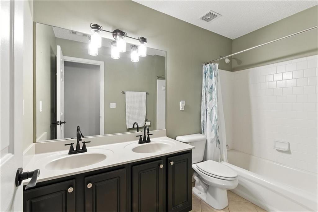 120 Quarrington Court Milton, GA 30004 - Photo 24 of 48 a bathroom with a double vanity sink toilet and shower