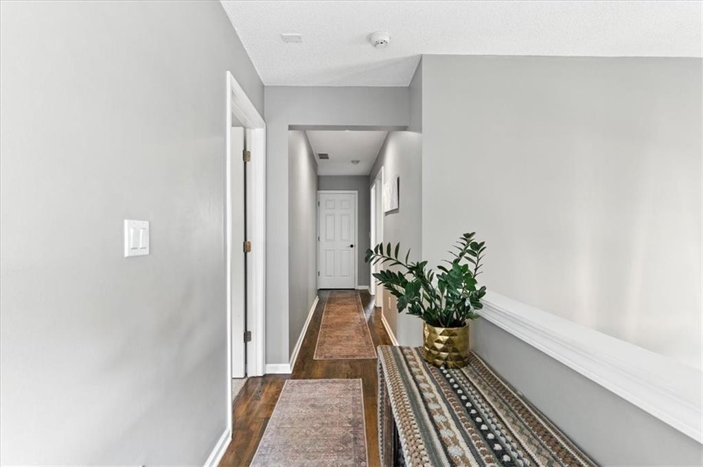 120 Quarrington Court Milton, GA 30004 - Photo 26 of 48 a view of a hallway with wooden floor and a potted plant