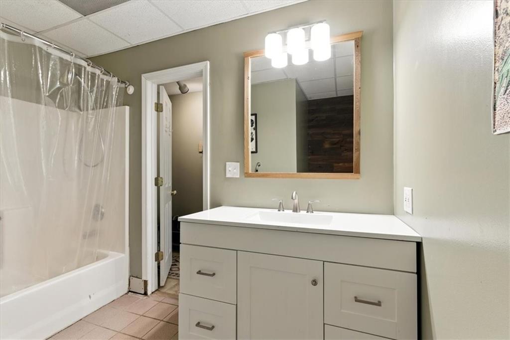 120 Quarrington Court Milton, GA 30004 - Photo 29 of 48 a bathroom with a sink a mirror a bathtub and shower