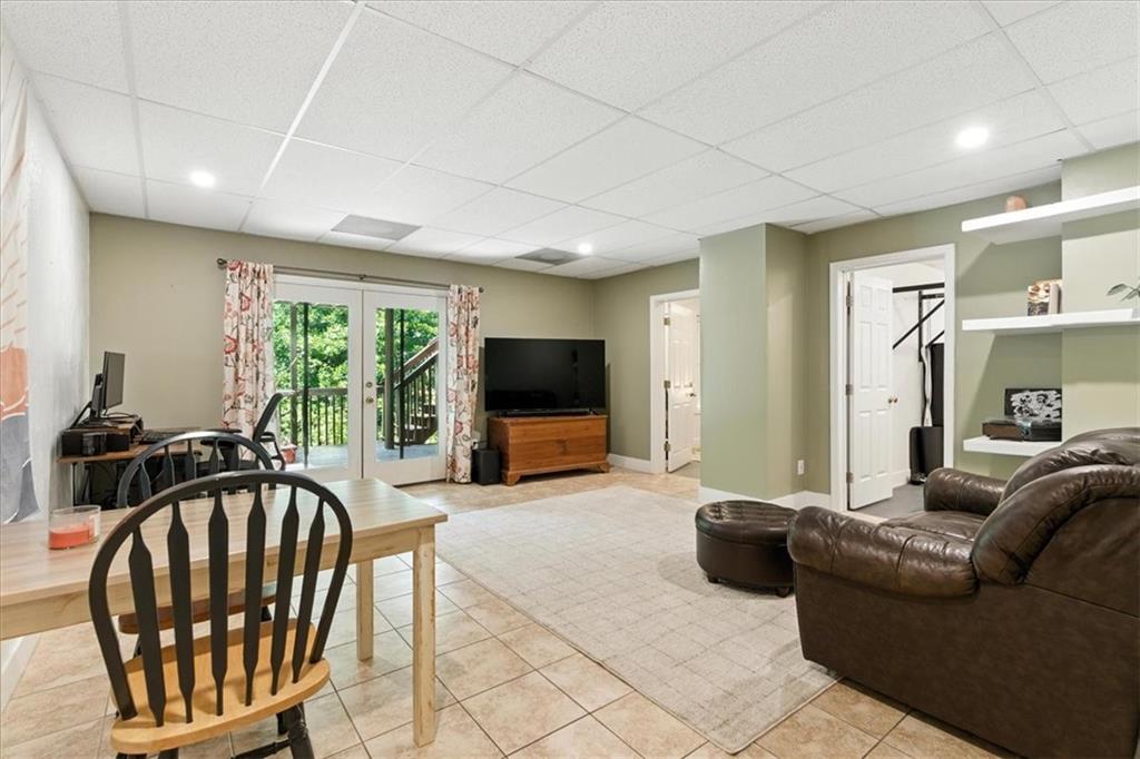 120 Quarrington Court Milton, GA 30004 - Photo 30 of 48 a living room with furniture a flat screen tv and a large window