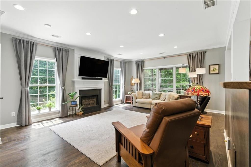 120 Quarrington Court Milton, GA 30004 - Photo 4 of 48 a living room with furniture a fireplace a flat screen tv and a large window