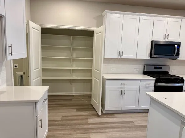 a kitchen with a cabinets and white appliances
