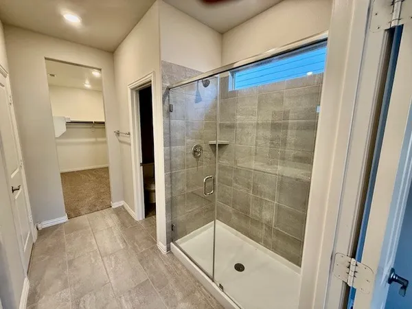 a bathroom with a shower and a sink