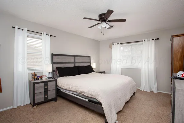 a bedroom with a bed and a flat tv screen