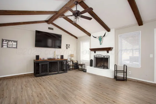 a living room with furniture a flat screen tv and a fireplace