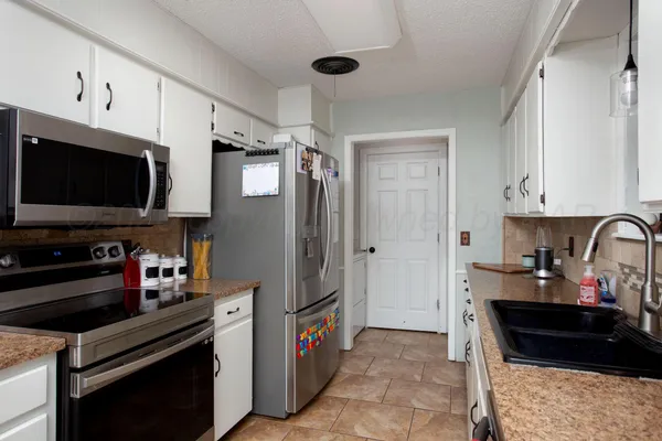 a kitchen with stainless steel appliances a stove and a refrigerator
