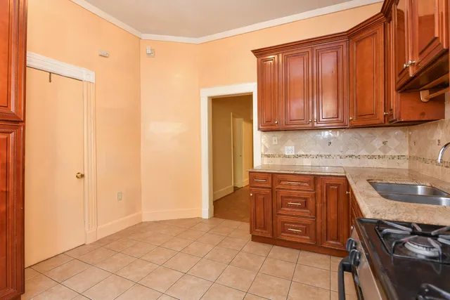 a kitchen with stainless steel appliances granite countertop a stove a sink and a microwave