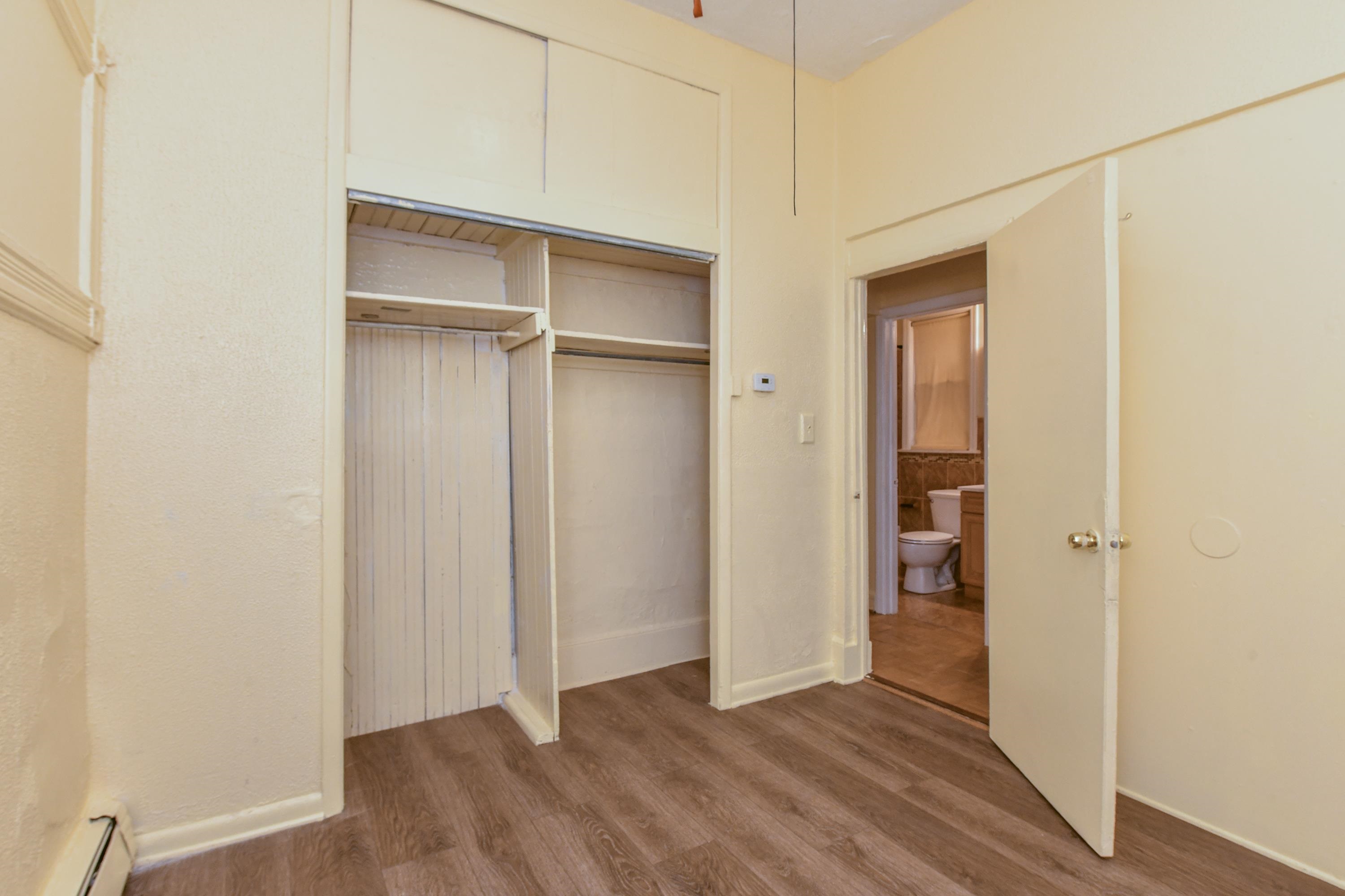 208 4th Street, Unit 1 Passaic, NJ 07055 - Photo 18 of 28 a view of an empty room with closet and wooden floor