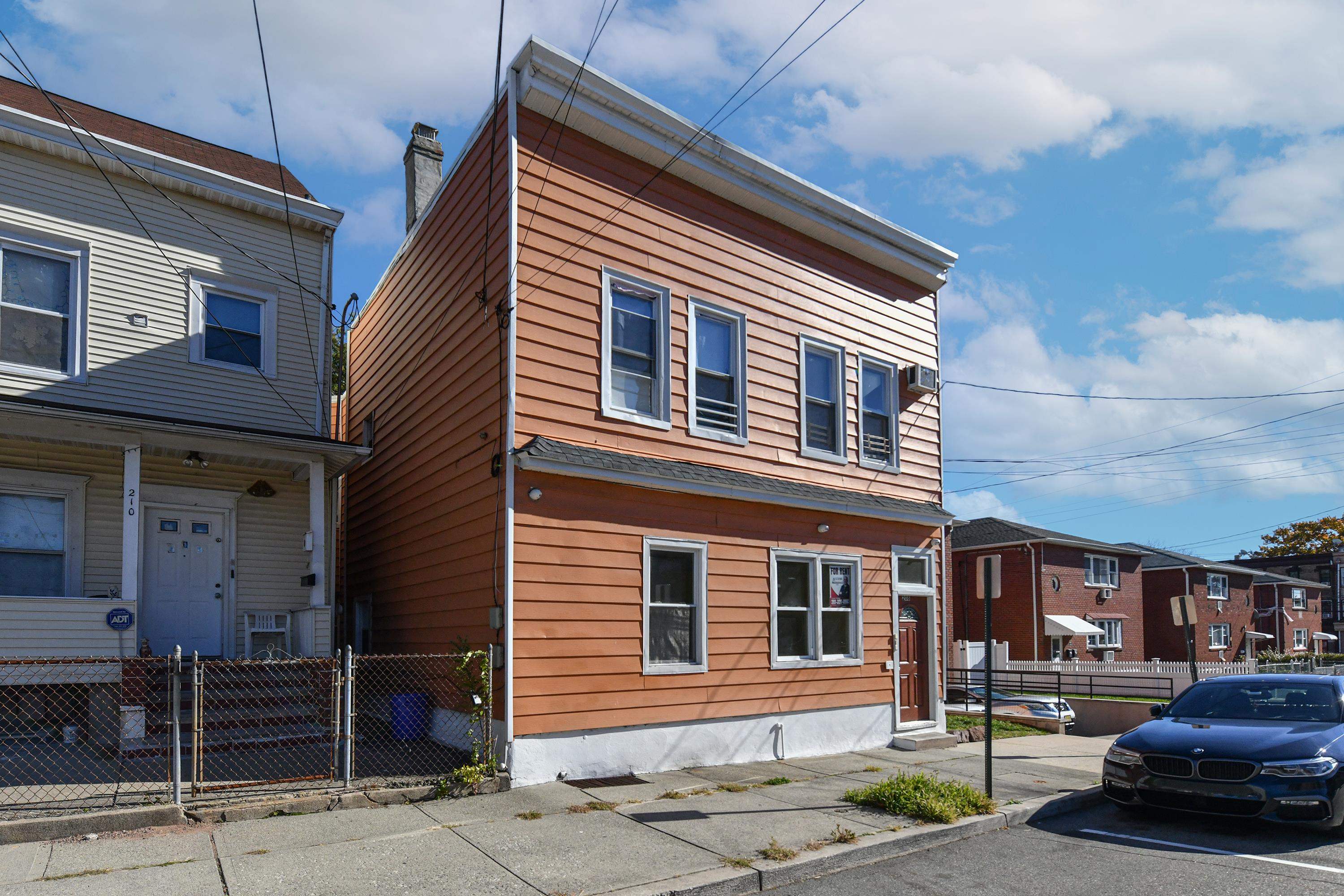 208 4th Street, Unit 1 Passaic, NJ 07055 - Photo 2 of 28 a front view of a house with parking space