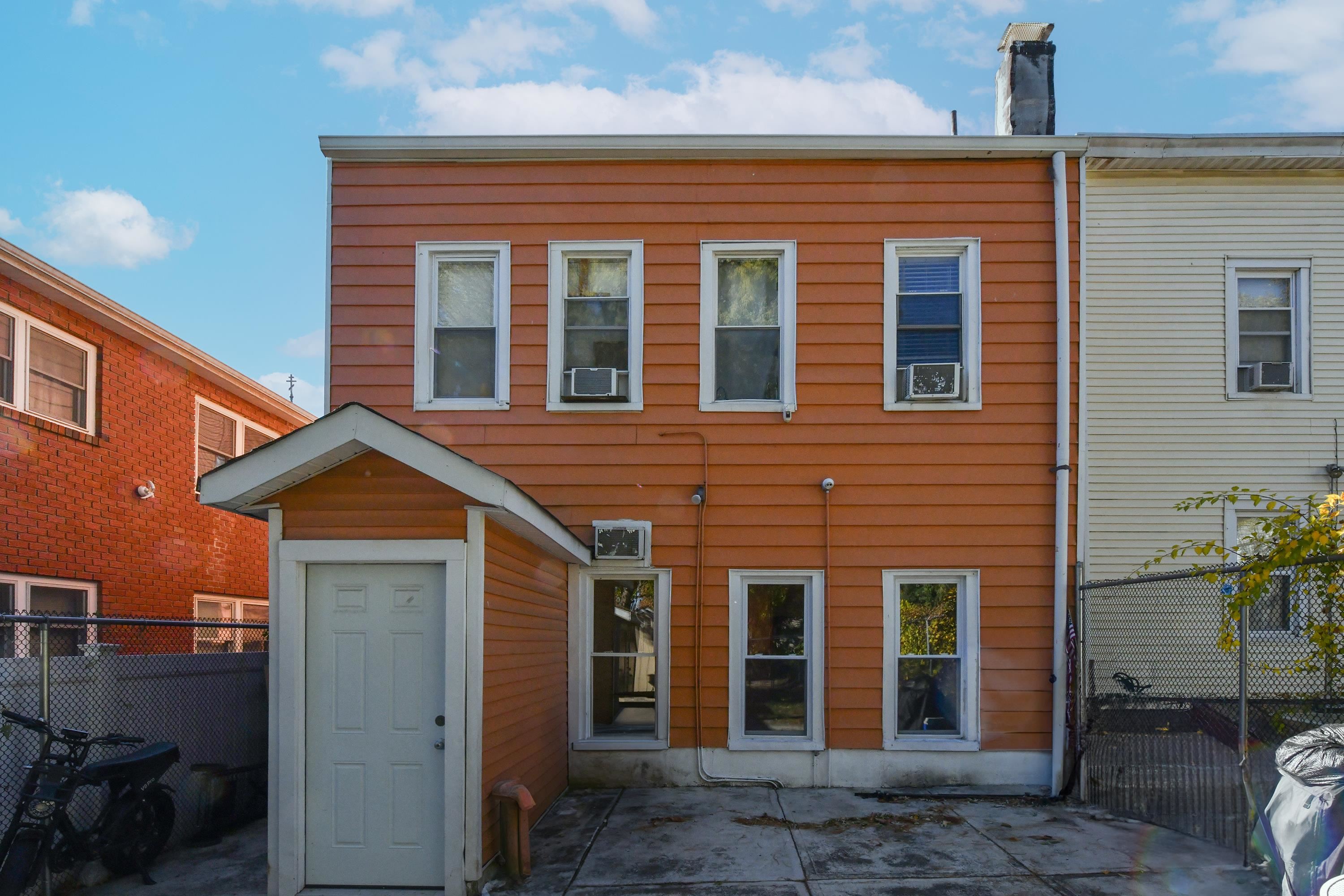 208 4th Street, Unit 1 Passaic, NJ 07055 - Photo 23 of 28 a front view of a house with a yard