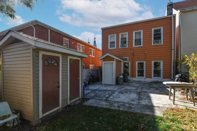 a view of a house with backyard and sitting area