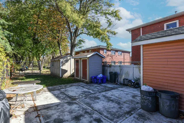 a view of a house with a yard covered with snow and trees