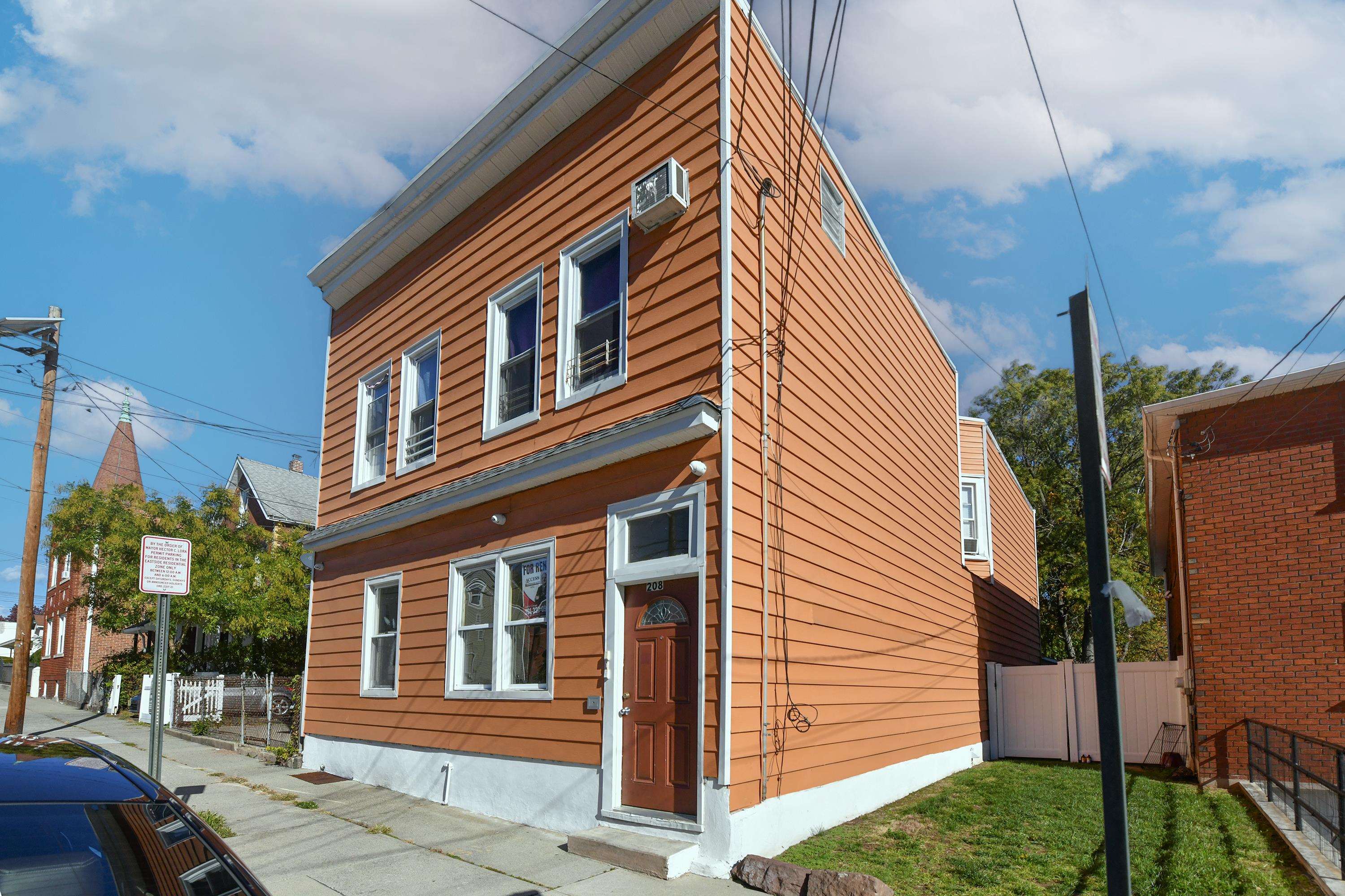 208 4th Street, Unit 1 Passaic, NJ 07055 - Photo 3 of 28 a front view of a house with a yard