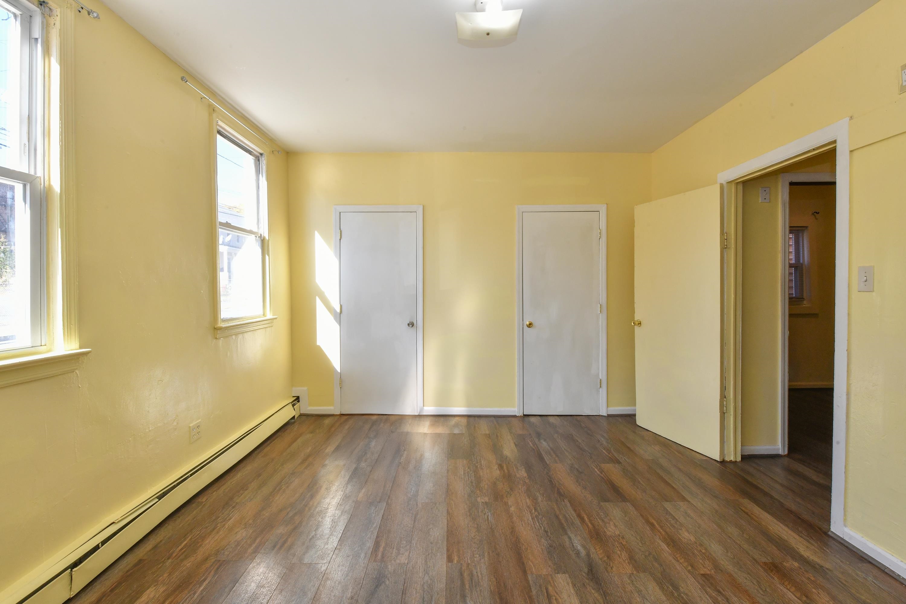 208 4th Street, Unit 1 Passaic, NJ 07055 - Photo 6 of 28 a view of wooden floor in an empty room