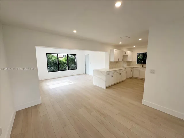 a view of an empty room with a fireplace