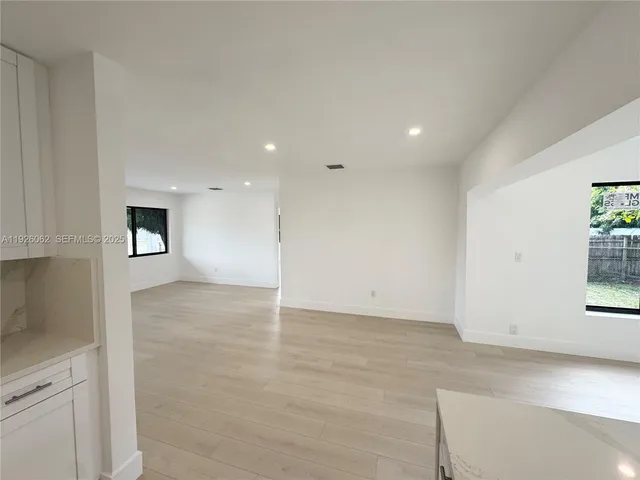 an empty room with windows and closet