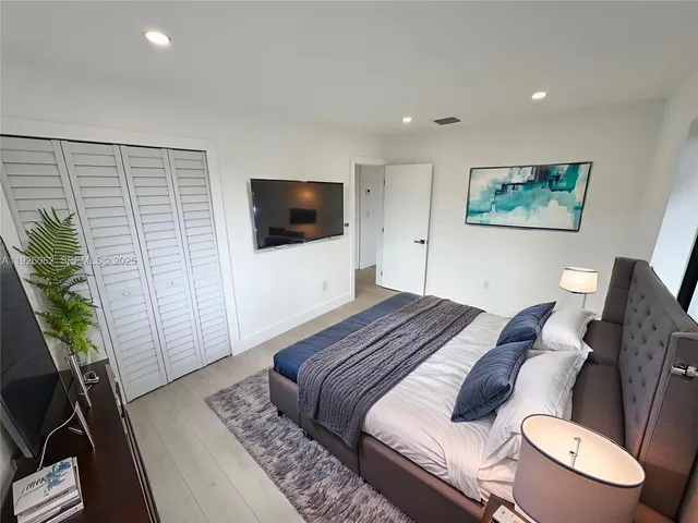 a bedroom with bed and window