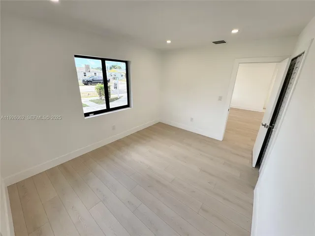 a view of a room with wooden floor and windows