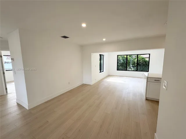 a view of a kitchen with a sink and a large window