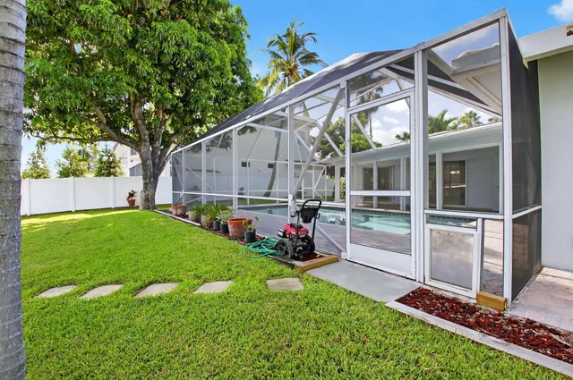 a swimming pool with outdoor seating and yard