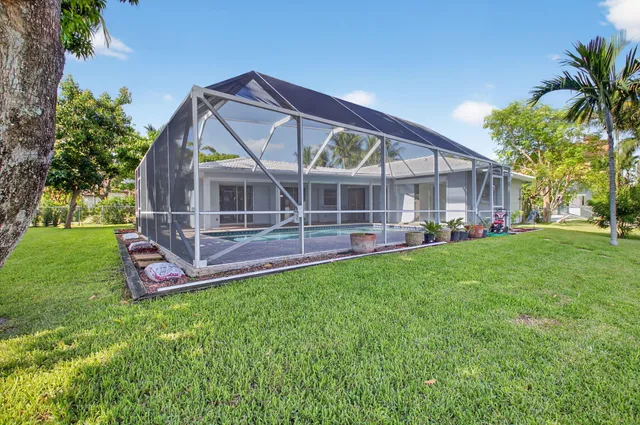 an aerial view of a house with a yard and garden